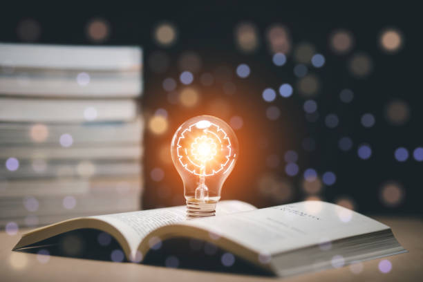 istock Thinking and creative concept, Light bulb on the Book and light bulb style bokeh vintage dark background,Concept The idea of reading books, knowledge, and searching for new ideas. 1429067104