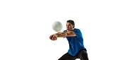 Studio shot of young man, volleyball player playing volleyball isolated on white studio background. Sport, gym, team sport, challenges