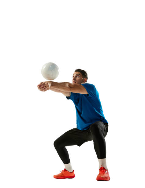 Receiving the ball. One volleyball player training with ball isolated on white studio background. Sport, gym, team sport, competition, emotions