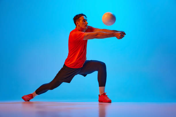 istock Receiving ball. Volleyball player training with ball isolated on blue studio background in neon light. Sport, gym, team sport, challenges 1429073747