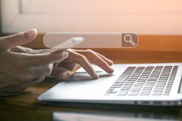 Photo of Hand of businessman typing text on laptop keyboard, Searching information data on internet networking concept.