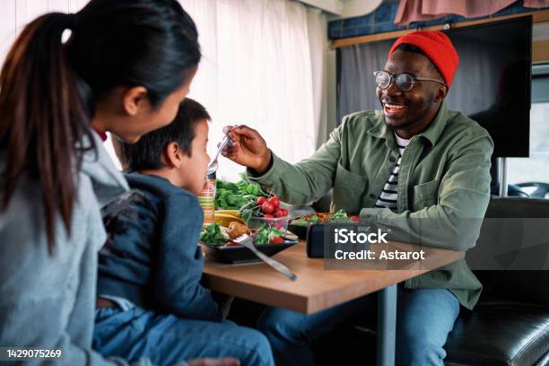 A Happy Family Having Lunch In Their Home On The Wheel Stock Photo - Download Image Now