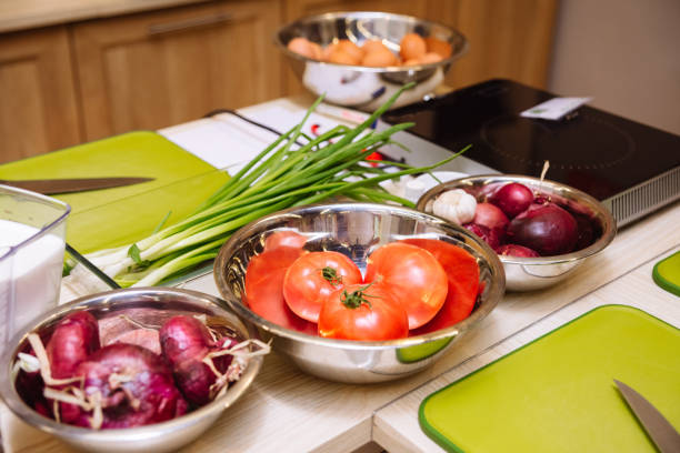 istock Cooking tables (working stations) prepared before the cooking master class. Cutting boards, raw food, kitchen utensils. 1429076563