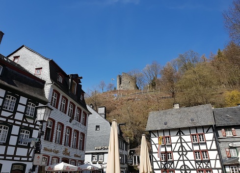 Nice view from the square in Monschau of the ruin with the old historic buildings