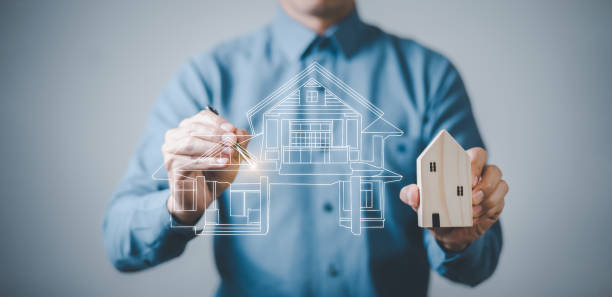 istock engineering and architecture drawings concept, Engineer man hold house on virtual screen of architect ,Insurance agent with model of house on light background,Property insurance and security concept. 1429078593