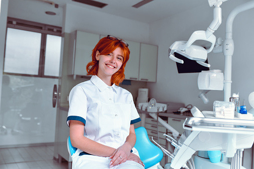 Dental Nurse Smiling After Sanitizing Equipment