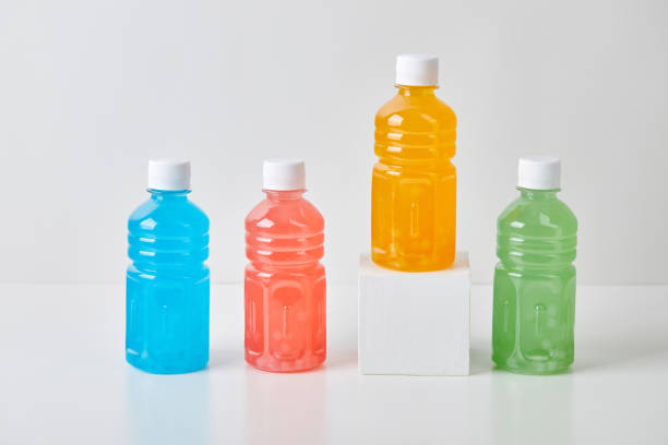 istock Four small bottles with colorful drinks on white background 1429079651