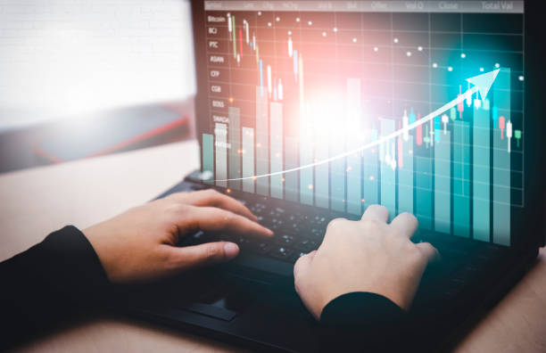 istock woman interacting with laptops, phones, and tablets with featuring stock tickers or graphs, cryptocurrency and new trading platforms, ideas and perspectives, Stock investment, technology 1429082145