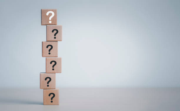 istock Hand hold Wooden cube block in question mark mean what on cement table background, column of wooden blocks with question sign mark. copy space,FAQ frequently asked questions, Answer, Information 1429082149