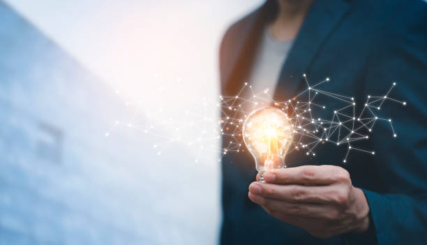 istock business hand holding illuminated light bulb, idea, innovation and inspiration concept.concept of creativity with bulbs that shine glitter, creativity with bulbs that shine glitter.Inspiration of idea 1429082423