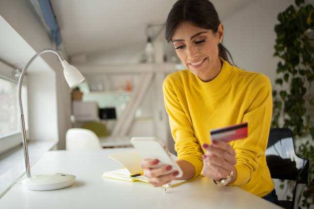 istock Cheerful  woman doing online shopping 1429086089