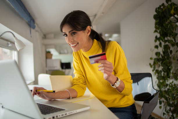 istock Cheerful  woman doing online shopping 1429086099