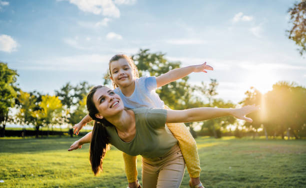 istock Young mother carrying daughter on her back 1429087076