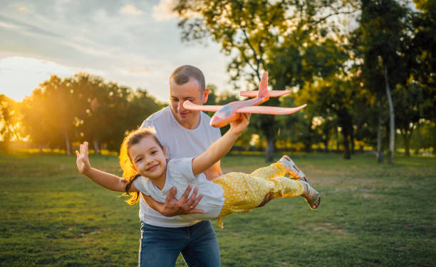 istock Father and daughter playing together in the park 1429087295