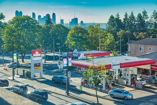Cars stand at a gas station in Vancouver BC Canada on a sunny morning.