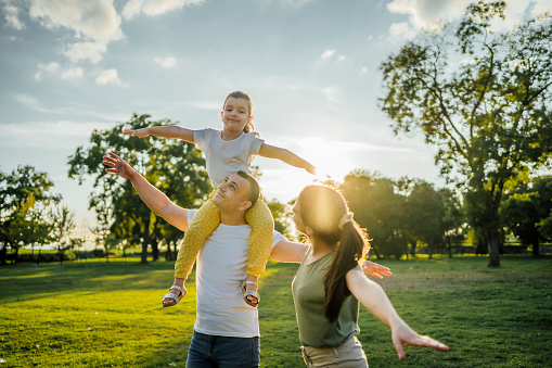 Happy young family enjoying time together in the park