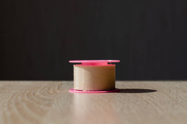 istock Plastic spool with patch. Medical antibacterial patch and glue. Dressing. Scotch. Medical equipment. 1429089139