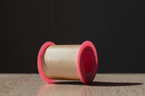 istock Plastic spool with patch. Medical antibacterial patch and glue. Dressing. Scotch. Medical equipment. 1429089239