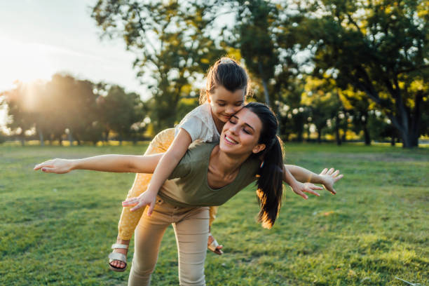 istock Young mother carrying daughter on her back 1429090610