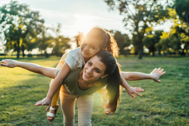 istock Young mother carrying daughter on her back 1429090779
