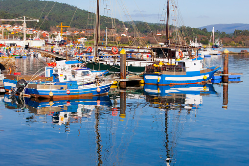 Fishing boats moored, harbor dock. O Freixo harbor, Outes, A Coruña province, Galicia, Spain.