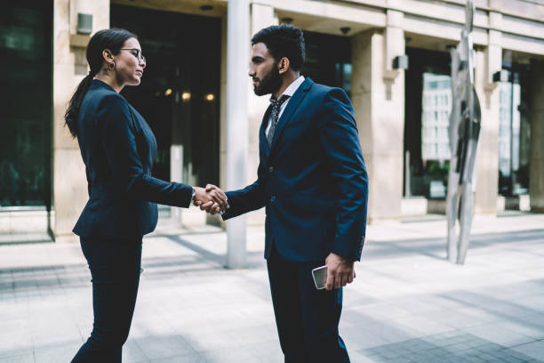 istock Colleagues greeting each other in street 1429097121