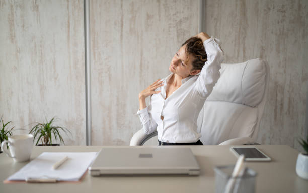 istock young woman stretching at work while sitting at desk having neck pain 1429100575