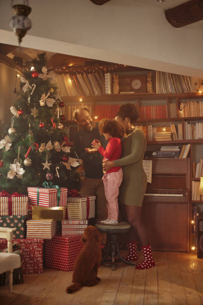 istock Multiracial family decorating Christmas tree at home 1429108941