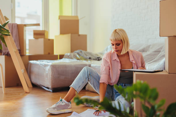 istock Woman moving in apartment and working on floor. 1429109135