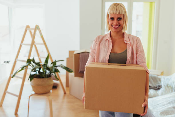 istock Smiling woman holding box. 1429109244