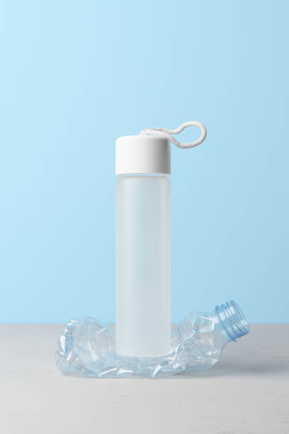 istock No plastic, Zero Waste, Sustainable Lifestyle. Choice Plastic Free Items alternative to disposable. Crumpled plastic bottle and glass bottle on pastel blue background. 1429111109