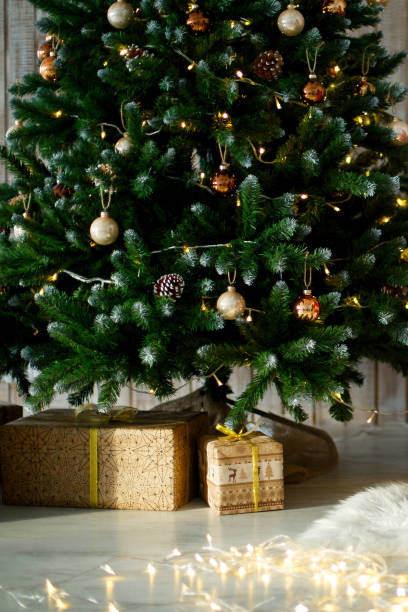 istock gifts on wooden floor, in gift boxes under christmas tree 1429111129