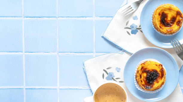 Traditional Portuguese dessert Pastel de nata on blue tile stock photo