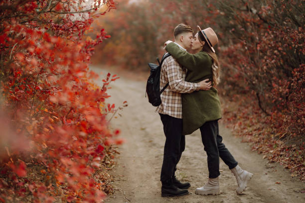 Lovely hipster couple resting in nature.  Autumn Fashion, style concept.