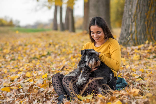 istock Girls enjoy in autumn magic with dog 1429117426