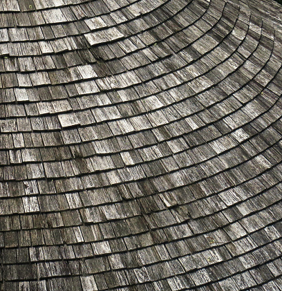 close up of an old, weathered wood shingled roof, on a farm building outside Merano, Italy, in the Alps