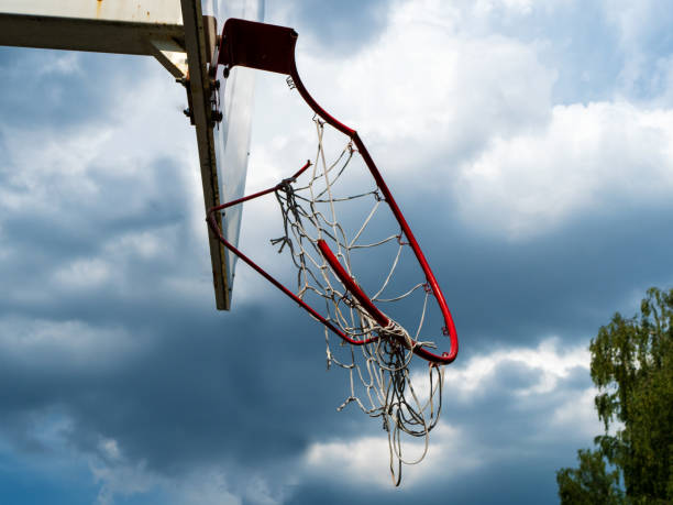 istock Broken basketball hoop against gray storm clouds 1429126348