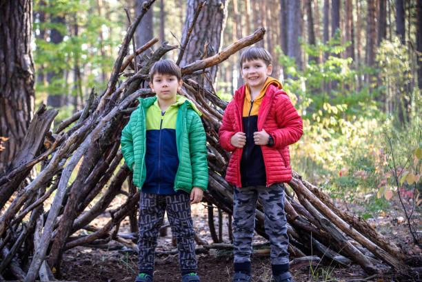 istock Two sibling brothers boys In the spring or autumn pine forest pl 1429127071