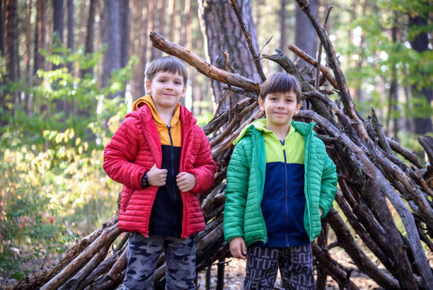 istock Two sibling brothers boys In the spring or autumn pine forest pl 1429127098