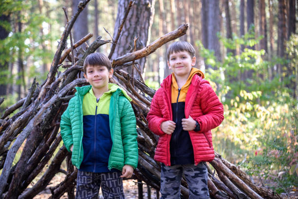 istock Two sibling brothers boys In the spring or autumn pine forest pl 1429127103