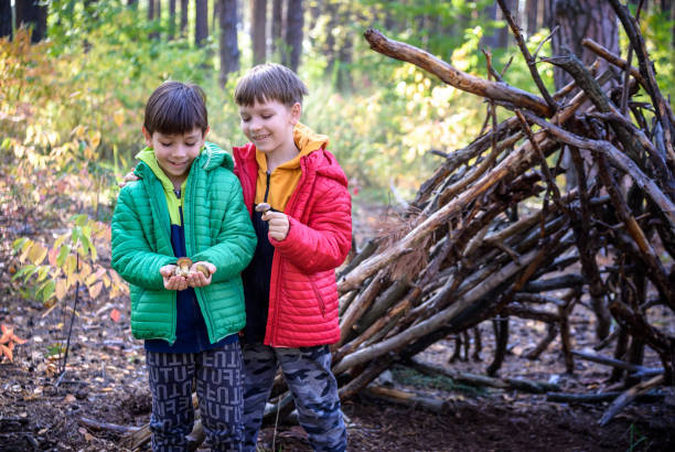 istock Two sibling brothers boys in the spring or autumn pine forest pl 1429127140