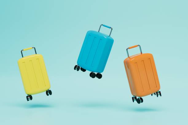 istock multi-colored luggage suitcases flying on a blue background. 3D render 1429133527