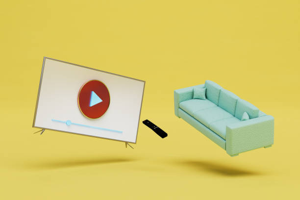 istock watching videos on the TV. sofa, remote control and smart TV on a yellow background. 3D render 1429133553