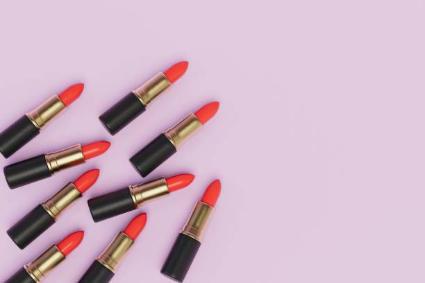 istock several tubes of red lipstick on a pink pastel background. copy paste, copy space. 3D render 1429133655