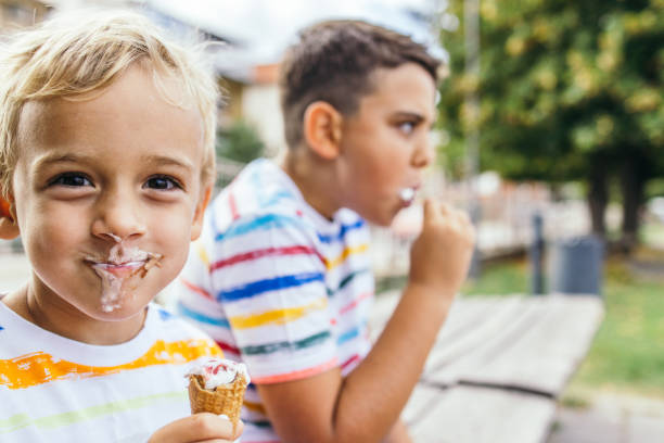 istock Messy Caucasian toddler boy eating ice cream 1429135870