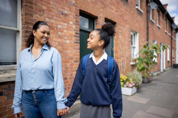 istock Loving mother taking her daughter to school 1429136041