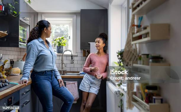 Happy Mother And Daughter Bonding At Home Stock Photo - Download Image Now - Teenager, Parent, Talking