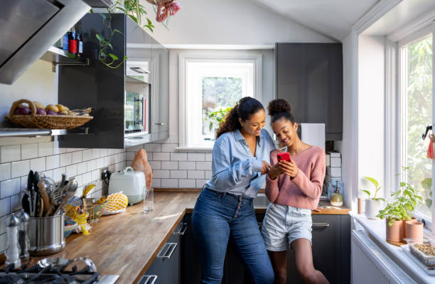 istock Mother and daughter bonding while watching video on social media 1429136200