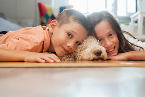 istock Happy kids with dog at home 1429137745
