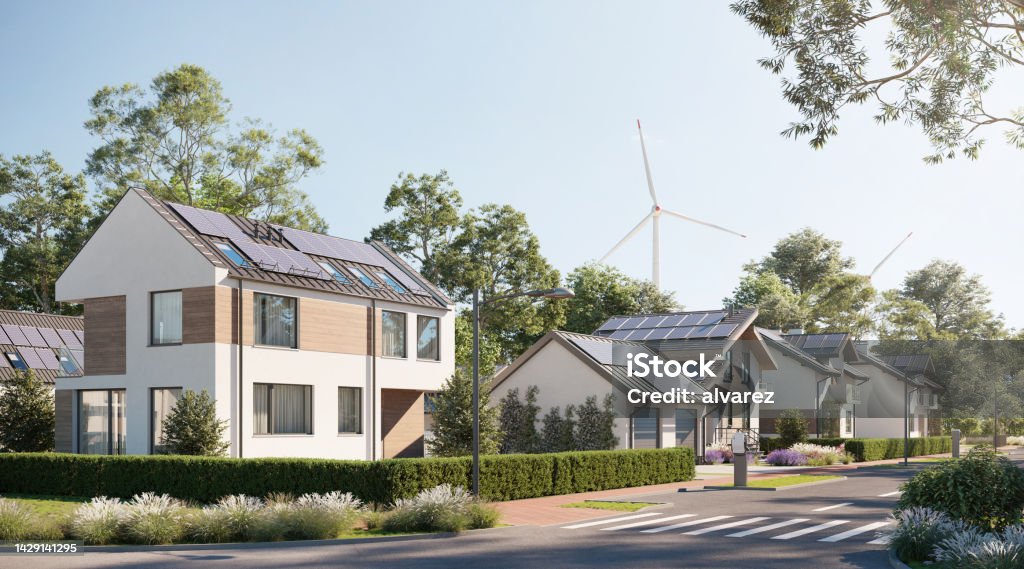 Digital renders of sustainable town with solar panels and wind energy 3d renders of sustainable houses with windmills. Sustainable sloped house with garden. House Stock Photo